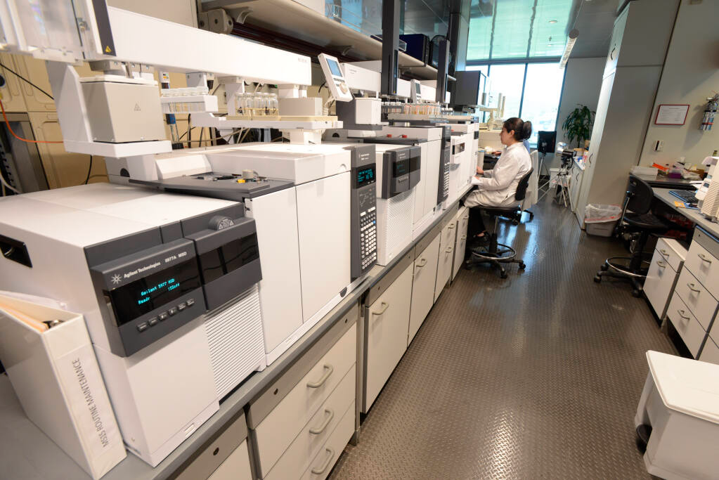 ETS Laboratories analyst Beronica Salomon works alongside one of the lab's many "Triple Quad" GC/MS/MS (QQQ) on June 9, 2015. The "triple quad" instruments are a new generation of technology that can detect and measure compounds at extremely low levels. This new technology has given winemakers access to innovative new analyses, and enhanced the performance of existing analytical tools. (courtesy of ETS Laboratories)